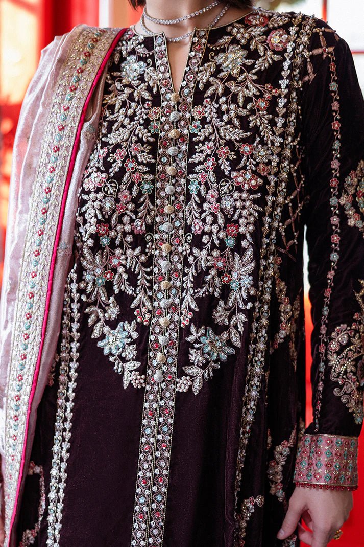 Model wearing Mushq DEJA VU - VELVET '24 Echoing Dreams, a deep maroon velvet outfit with intricate silver and pink embellishments, perfect for winter weddings. Available for Pakistani clothes online in the UK.