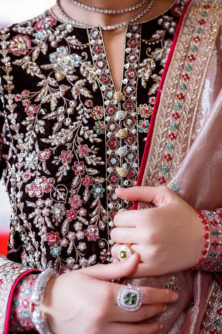 Model wearing Mushq DEJA VU - VELVET '24 Echoing Dreams, a deep maroon velvet outfit with intricate silver and pink embellishments, perfect for winter weddings. Available for Pakistani clothes online in the UK.