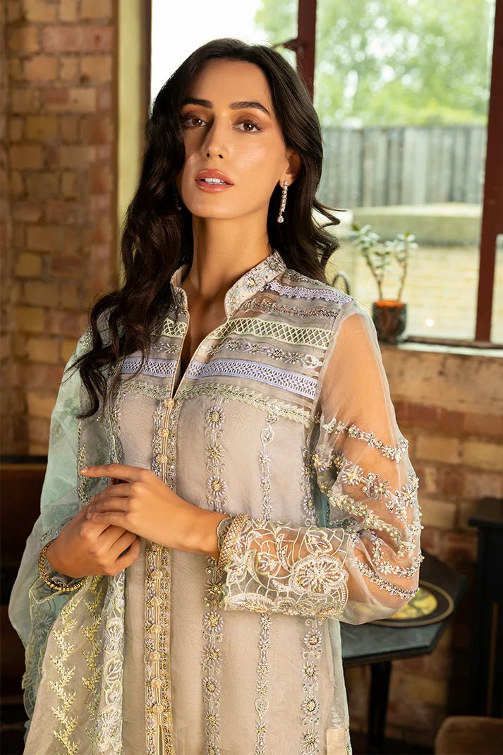 Model wearing Noelle from Mushq's Espoir Luxury Pret '24 in rich gold tones, showcasing luxury Pakistani clothes online in UK.