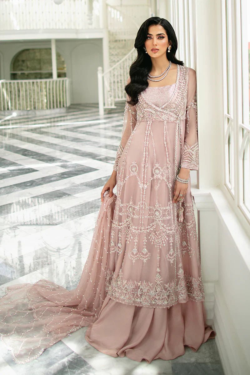 Model wearing Mushq's Delphine dress from the Fluer Luxury Eid Pret collection, showcasing elegant embroidery on a blush fabric, embodying chic Pakistani designer wear in the UK.