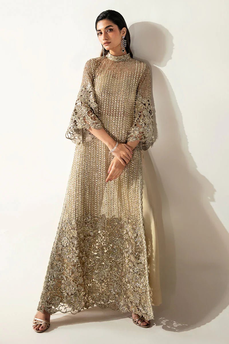 Model wearing Mushq's Eve dress from the Fluer Luxury Eid Pret collection. A dazzling gold Pakistani designer outfit with intricate embroidery, ideal for those seeking Pakistani Eid clothes in the UK.