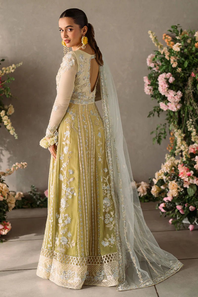 Model wearing Mushq Mastani Evening Luxury Chiffon Hira dress in pale yellow with intricate silver embroidery, ideal for Pakistani wedding clothes online in the UK.