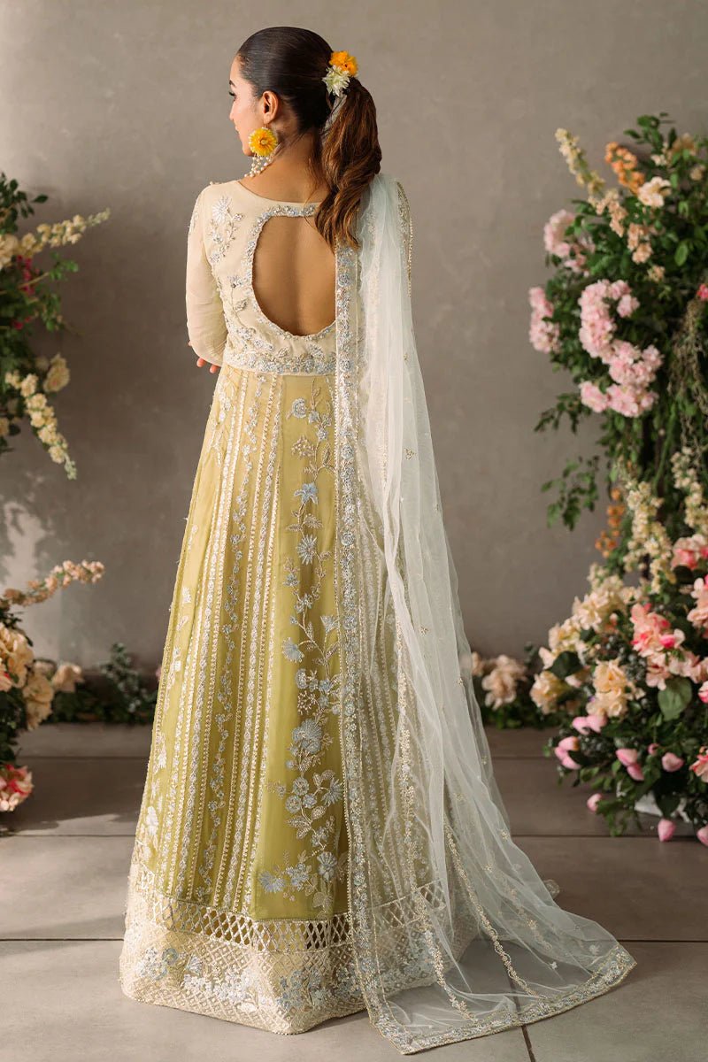 Model wearing Mushq Mastani Evening Luxury Chiffon Hira dress in pale yellow with intricate silver embroidery, ideal for Pakistani wedding clothes online in the UK.