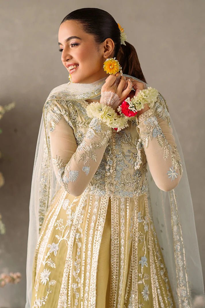 Model wearing Mushq Mastani Evening Luxury Chiffon Hira dress in pale yellow with intricate silver embroidery, ideal for Pakistani wedding clothes online in the UK.