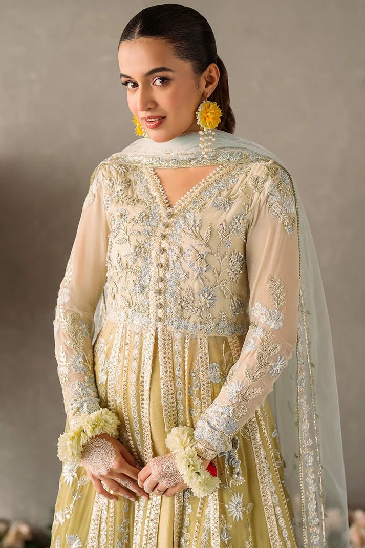 Model wearing Mushq Mastani Evening Luxury Chiffon Hira dress in pale yellow with intricate silver embroidery, ideal for Pakistani wedding clothes online in the UK.