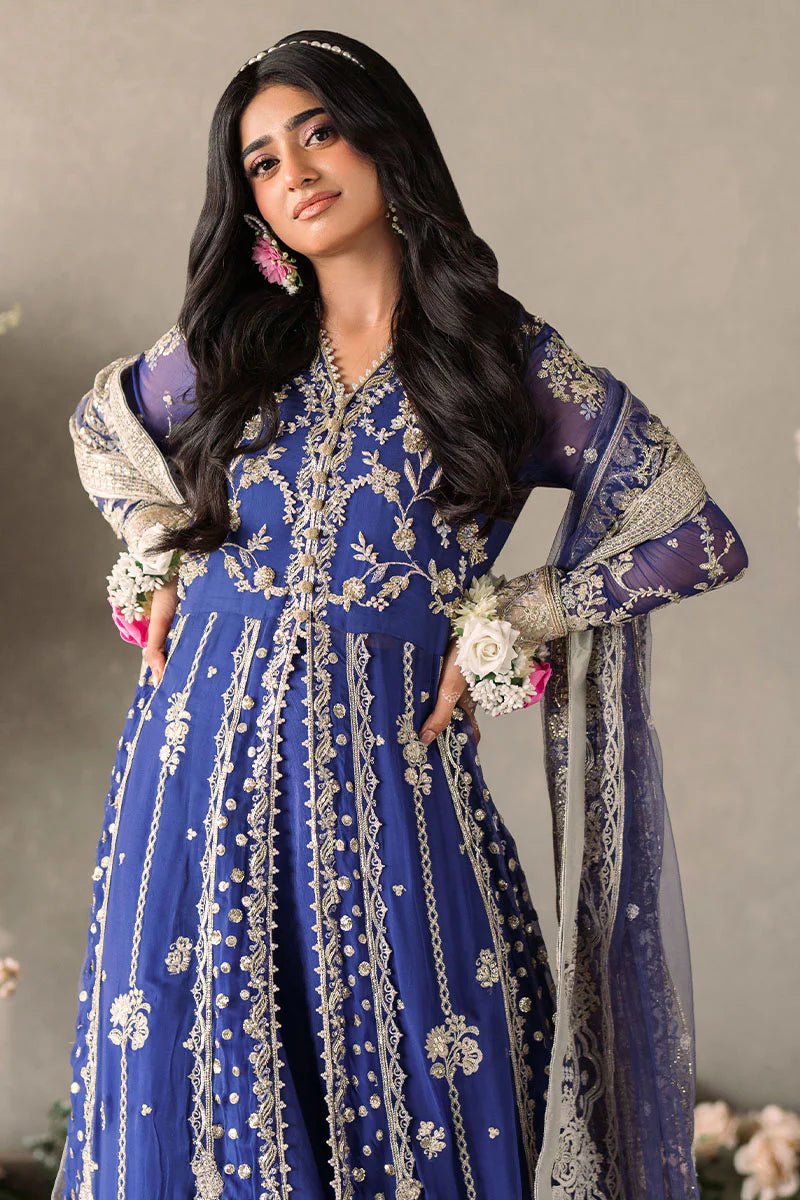 Model wearing Mushq Mastani Evening Luxury Chiffon Sehar dress in royal blue with intricate gold embroidery, perfect for Pakistani wedding clothes online in the UK.