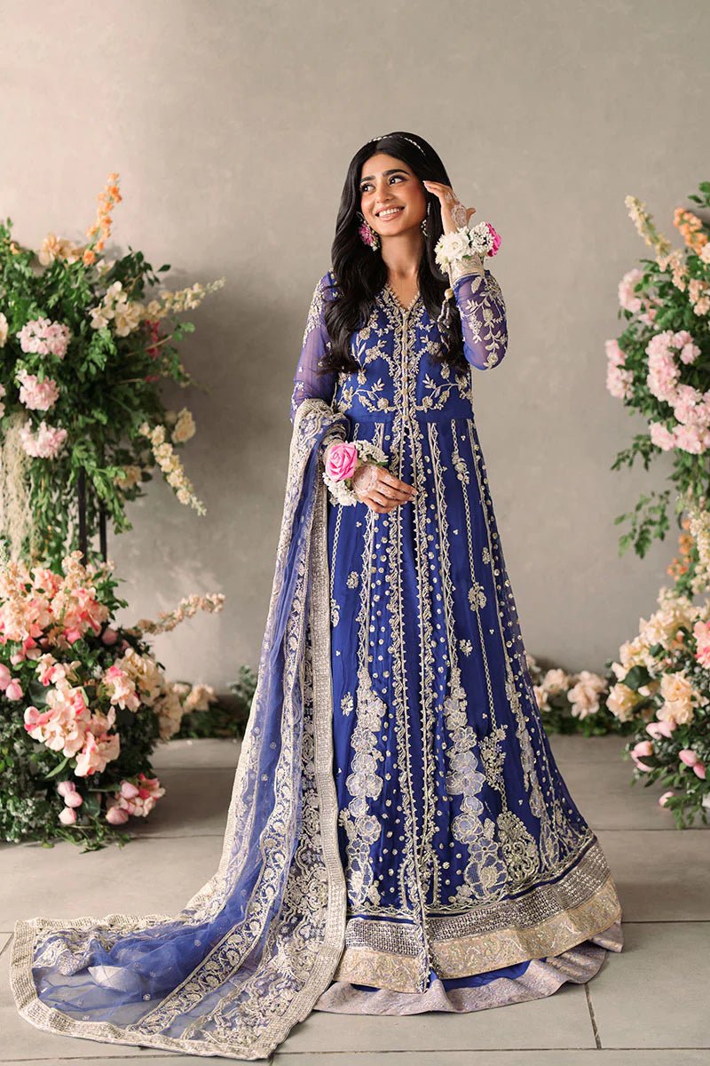 Model wearing Mushq Mastani Evening Luxury Chiffon Sehar dress in royal blue with intricate gold embroidery, perfect for Pakistani wedding clothes online in the UK.