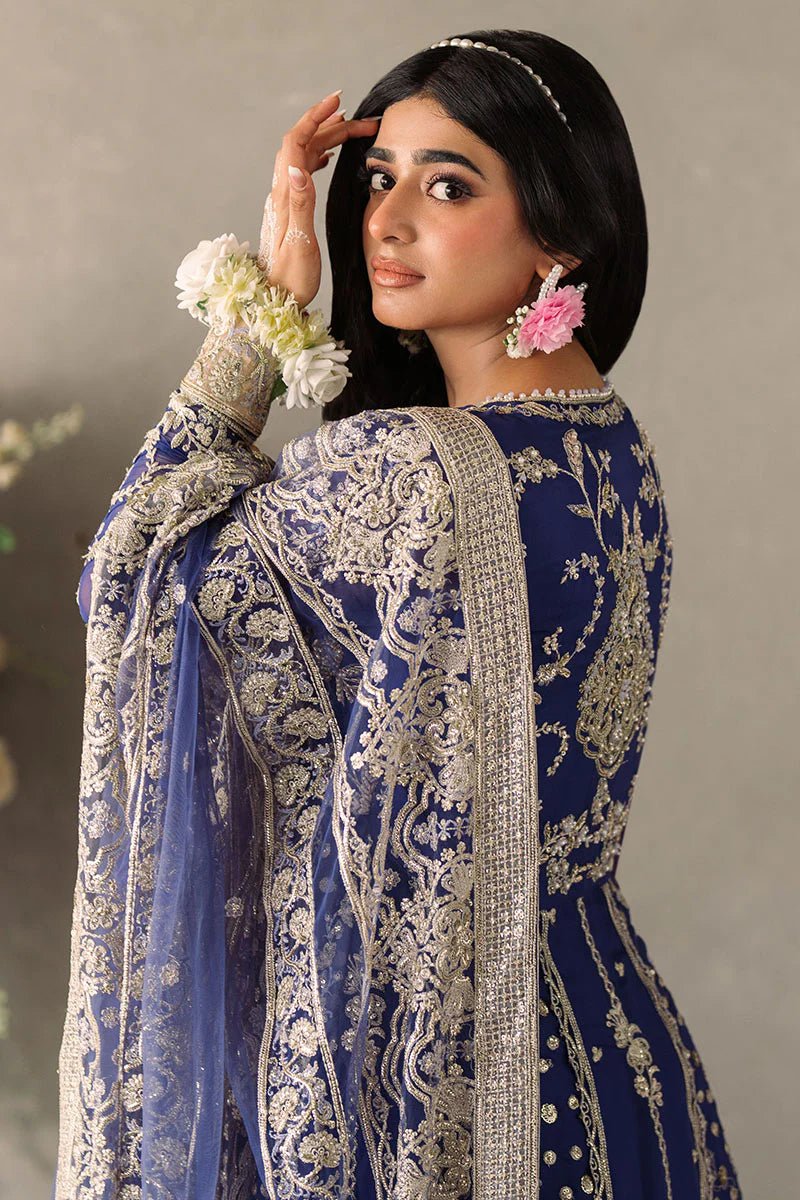 Model wearing Mushq Mastani Evening Luxury Chiffon Sehar dress in royal blue with intricate gold embroidery, perfect for Pakistani wedding clothes online in the UK.