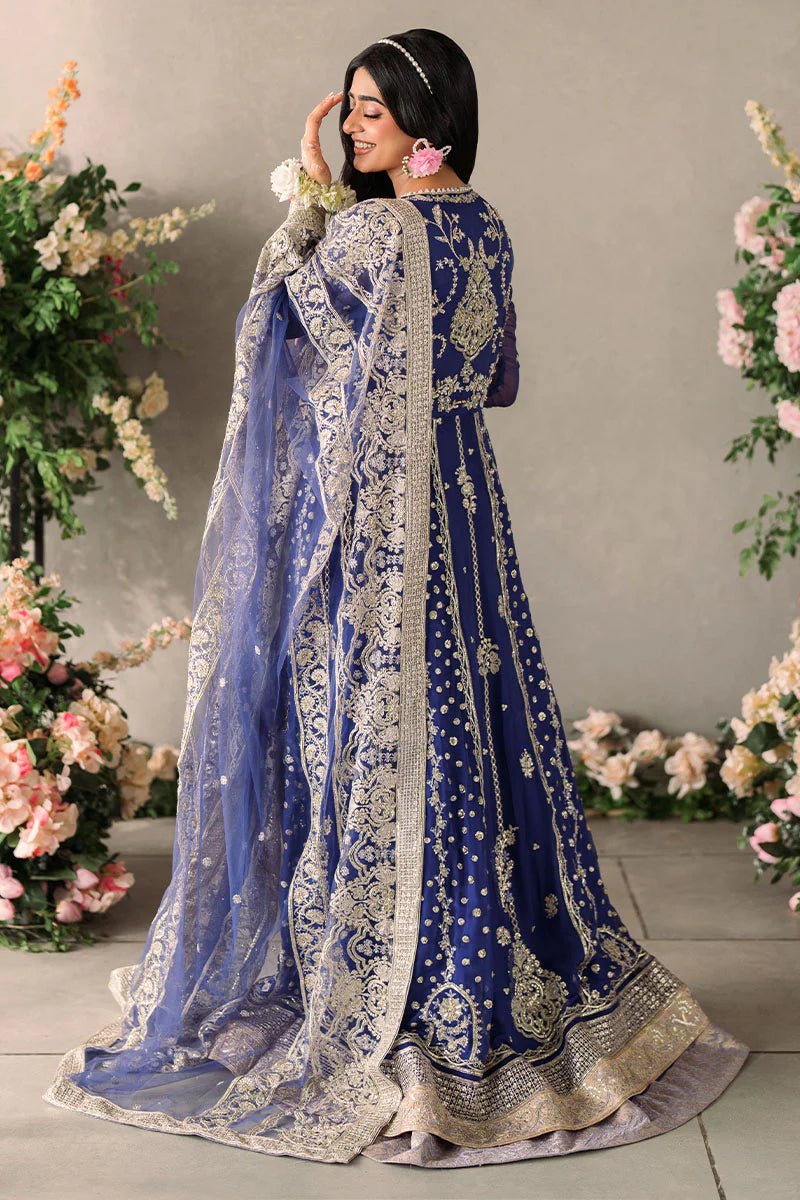 Model wearing Mushq Mastani Evening Luxury Chiffon Sehar dress in royal blue with intricate gold embroidery, perfect for Pakistani wedding clothes online in the UK.