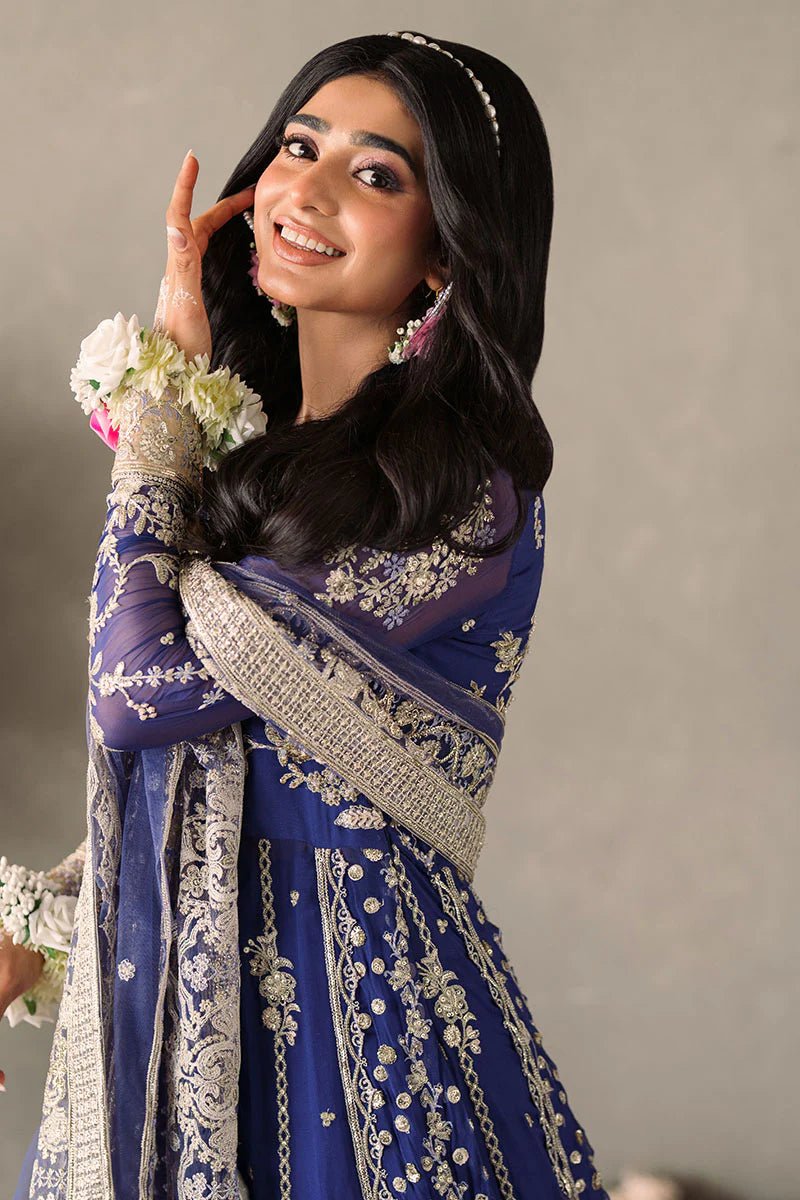 Model wearing Mushq Mastani Evening Luxury Chiffon Sehar dress in royal blue with intricate gold embroidery, perfect for Pakistani wedding clothes online in the UK.