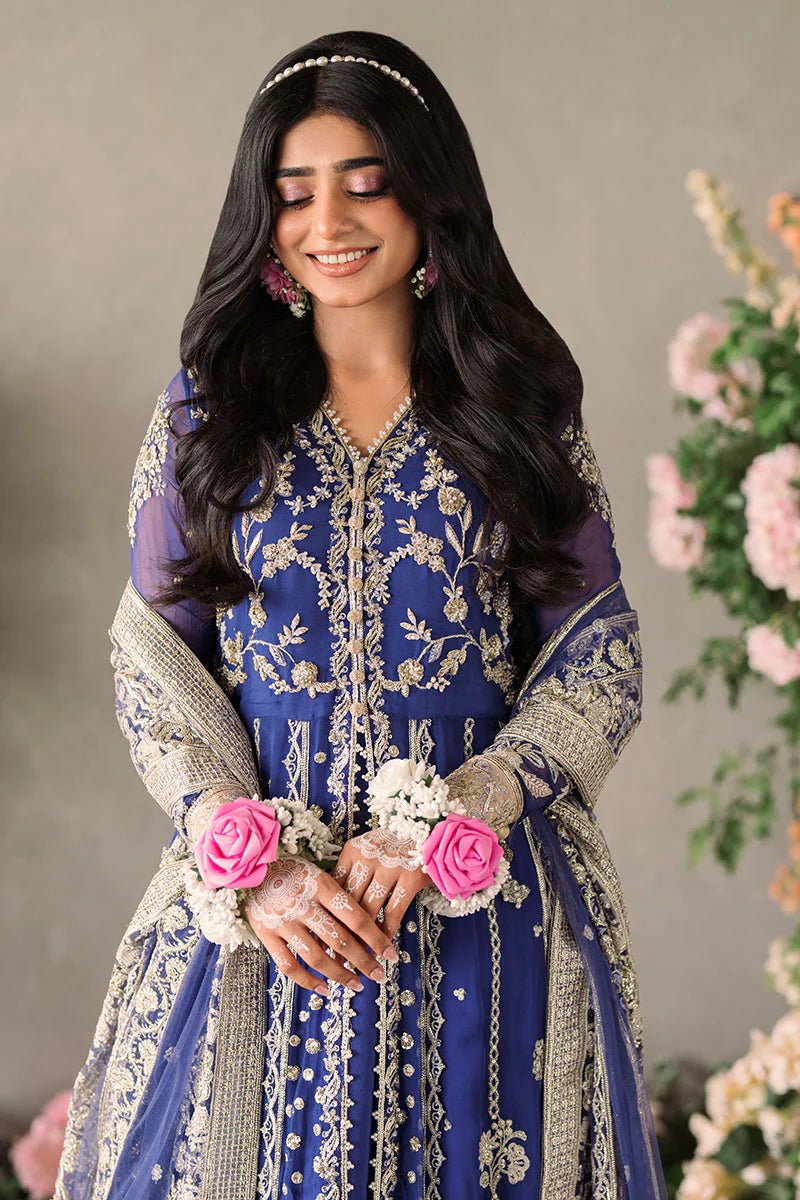 Model wearing Mushq Mastani Evening Luxury Chiffon Sehar dress in royal blue with intricate gold embroidery, perfect for Pakistani wedding clothes online in the UK.