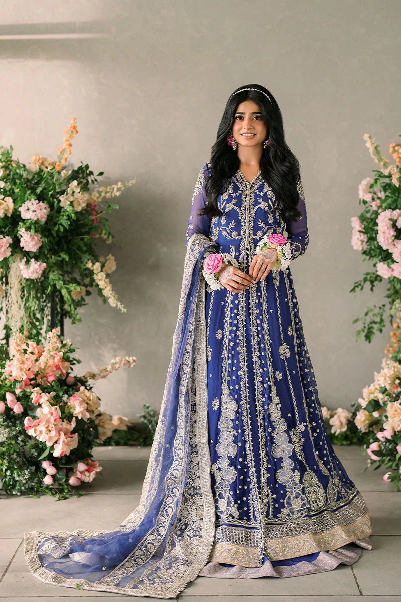 Model wearing Mushq Mastani Evening Luxury Chiffon Sehar dress in royal blue with intricate gold embroidery, perfect for Pakistani wedding clothes online in the UK.