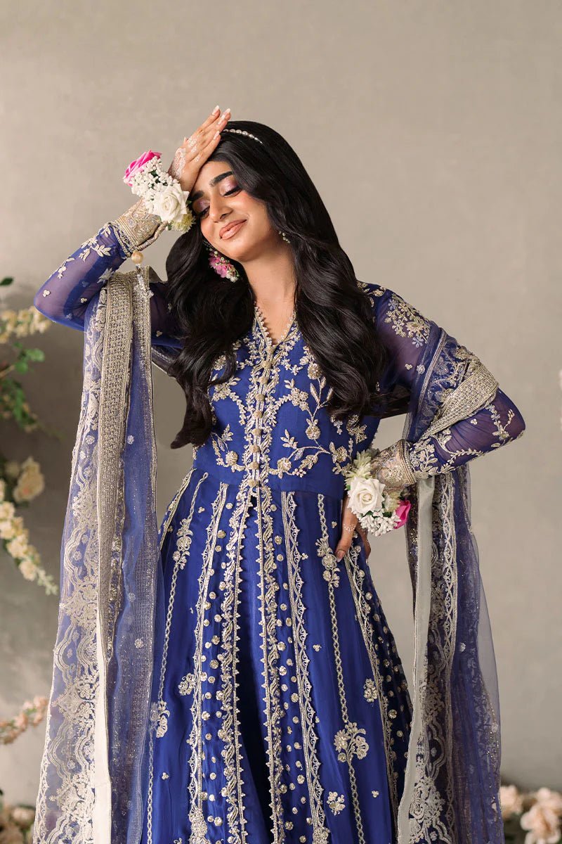 Model wearing Mushq Mastani Evening Luxury Chiffon Sehar dress in royal blue with intricate gold embroidery, perfect for Pakistani wedding clothes online in the UK.