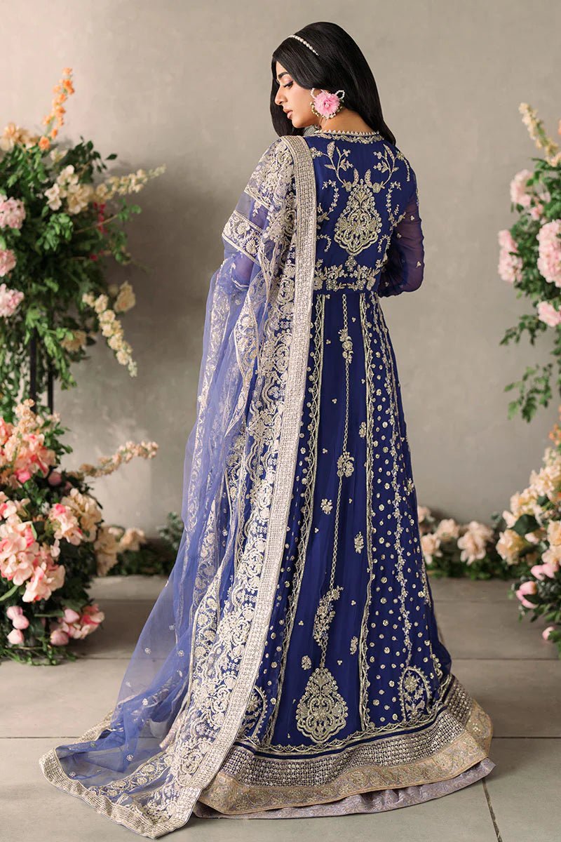 Model wearing Mushq Mastani Evening Luxury Chiffon Sehar dress in royal blue with intricate gold embroidery, perfect for Pakistani wedding clothes online in the UK.