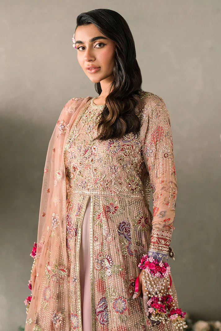 Model wearing Mushq Mastani Evening Luxury Chiffon Sona dress in peach, featuring intricate floral embroidery, ideal for Pakistani wedding clothes online in the UK.