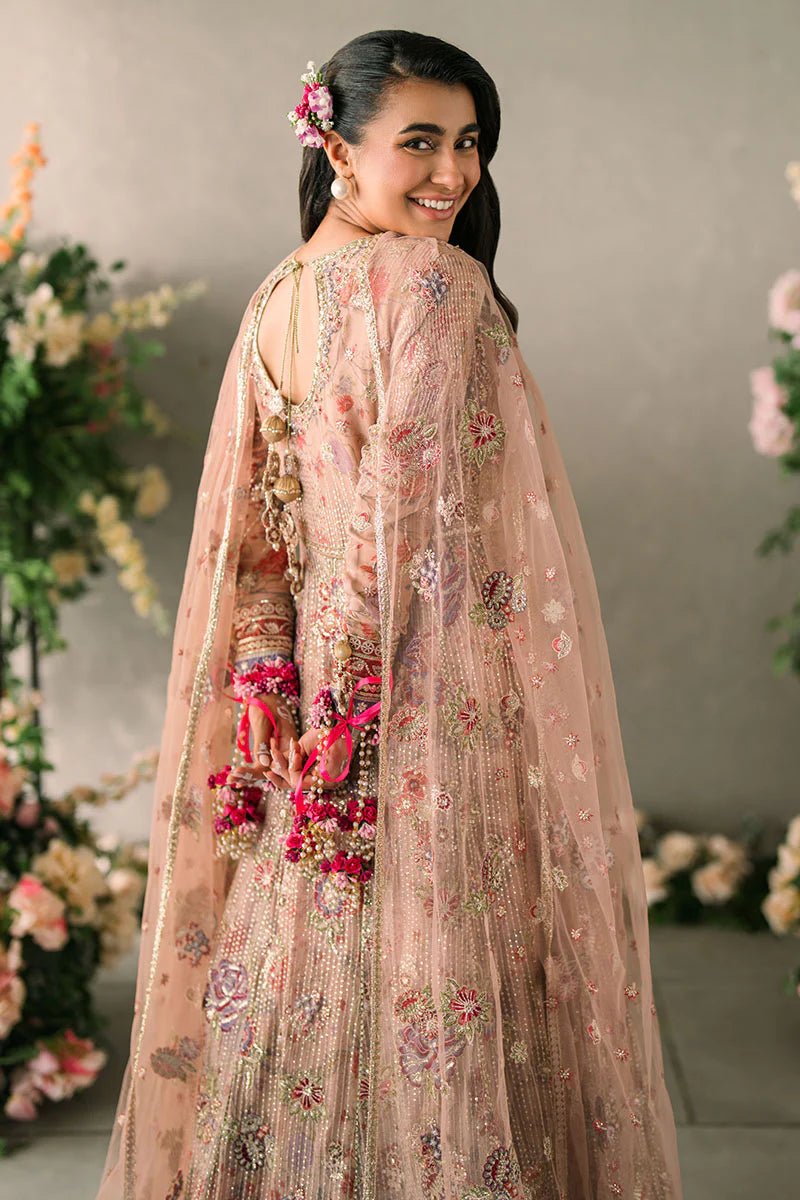 Model wearing Mushq Mastani Evening Luxury Chiffon Sona dress in peach, featuring intricate floral embroidery, ideal for Pakistani wedding clothes online in the UK.