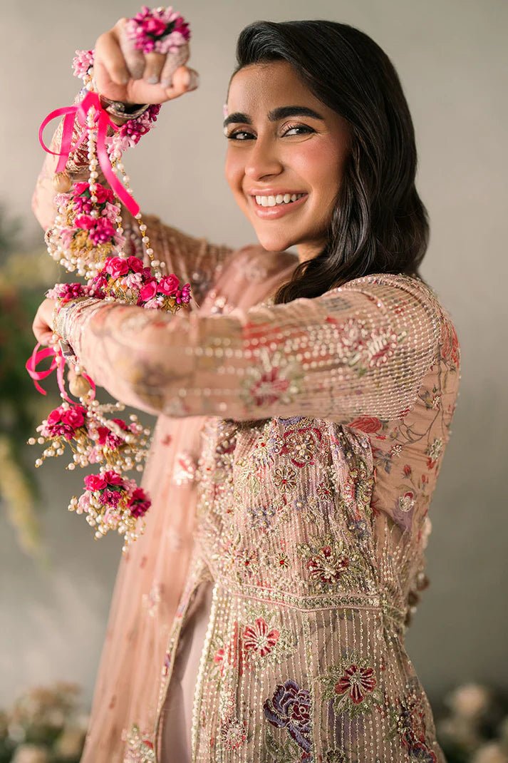 Model wearing Mushq Mastani Evening Luxury Chiffon Sona dress in peach, featuring intricate floral embroidery, ideal for Pakistani wedding clothes online in the UK.