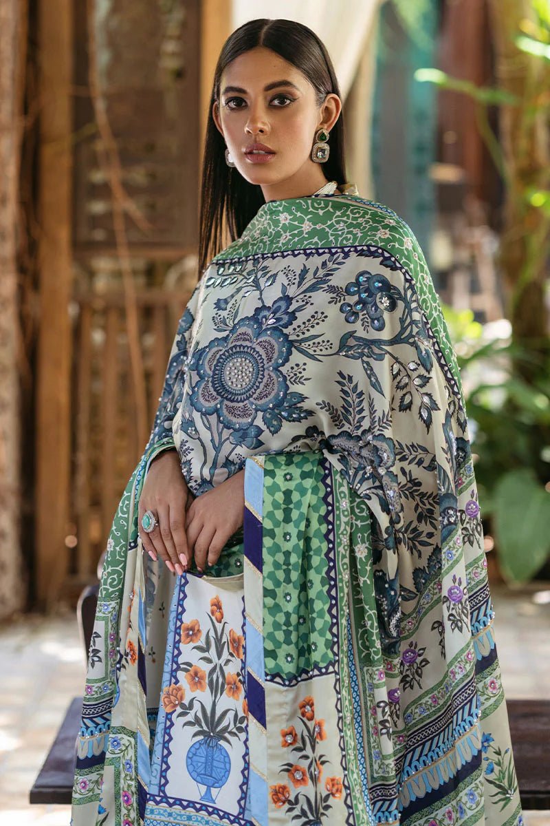 Model wearing Azure dress from Mushq's Nirvana Silk Edit, featuring intricate blue and green floral prints. Pakistani winter casual pret clothes available online in the UK.