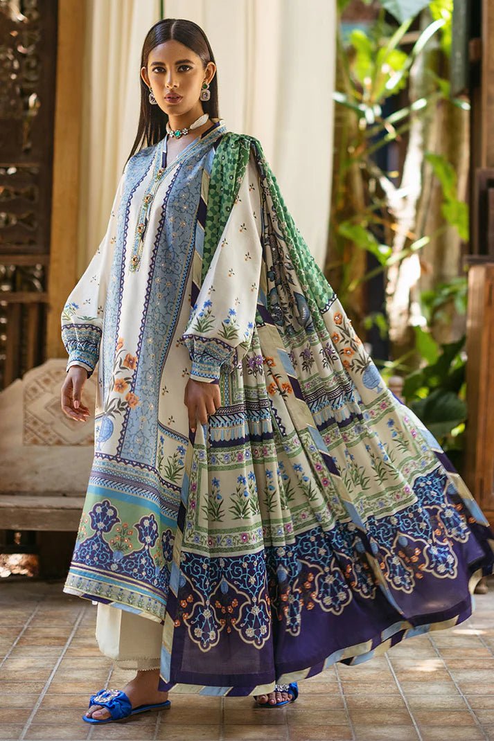 Model wearing Azure dress from Mushq's Nirvana Silk Edit, featuring intricate blue and green floral prints. Pakistani winter casual pret clothes available online in the UK.