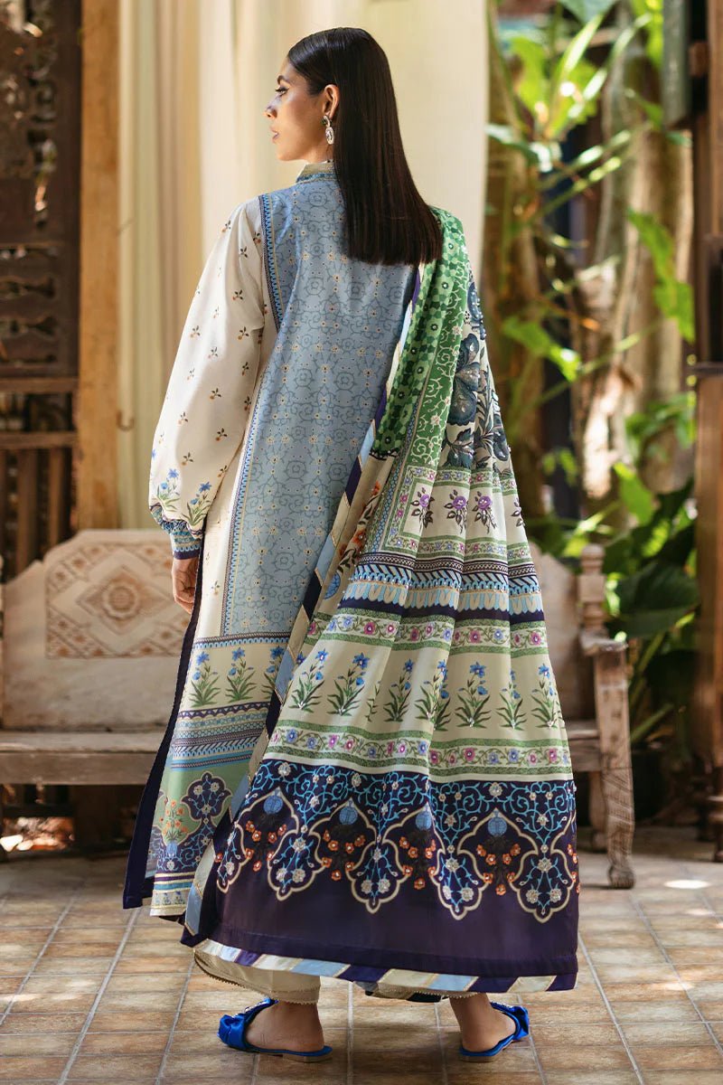 Model wearing Azure dress from Mushq's Nirvana Silk Edit, featuring intricate blue and green floral prints. Pakistani winter casual pret clothes available online in the UK.