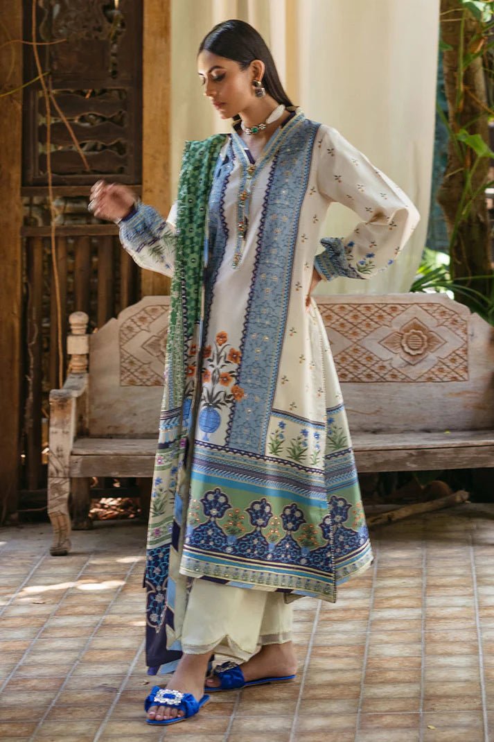 Model wearing Azure dress from Mushq's Nirvana Silk Edit, featuring intricate blue and green floral prints. Pakistani winter casual pret clothes available online in the UK.