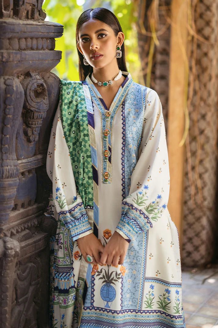 Model wearing Azure dress from Mushq's Nirvana Silk Edit, featuring intricate blue and green floral prints. Pakistani winter casual pret clothes available online in the UK.