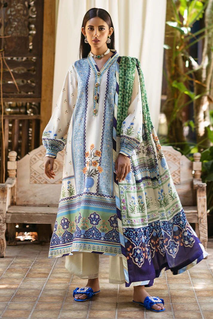 Model wearing Azure dress from Mushq's Nirvana Silk Edit, featuring intricate blue and green floral prints. Pakistani winter casual pret clothes available online in the UK.