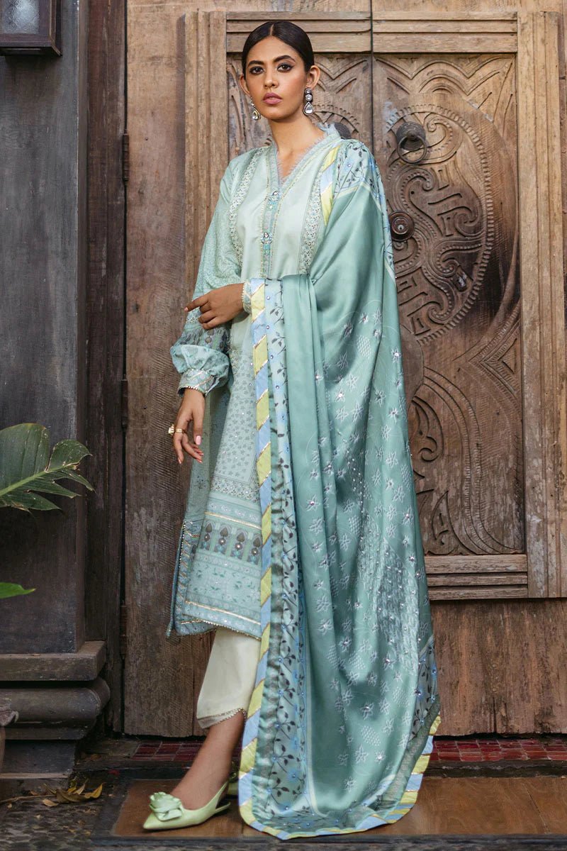 Model wearing Cerulean dress from Mushq's Nirvana Silk Edit, featuring elegant prints in shades of light blue and mint green. Pakistani winter casual pret clothes available online in the UK.