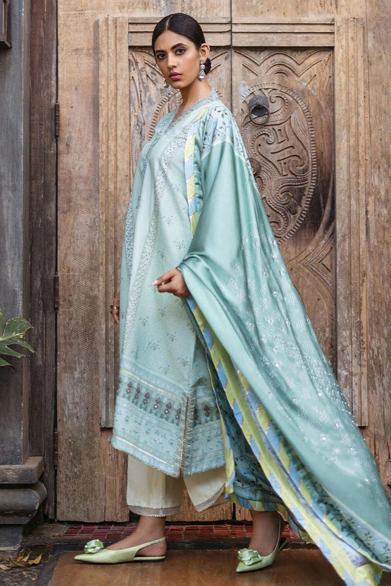 Model wearing Cerulean dress from Mushq's Nirvana Silk Edit, featuring elegant prints in shades of light blue and mint green. Pakistani winter casual pret clothes available online in the UK.