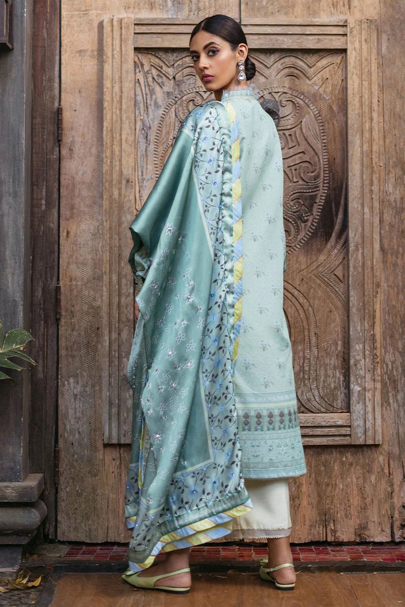 Model wearing Cerulean dress from Mushq's Nirvana Silk Edit, featuring elegant prints in shades of light blue and mint green. Pakistani winter casual pret clothes available online in the UK.