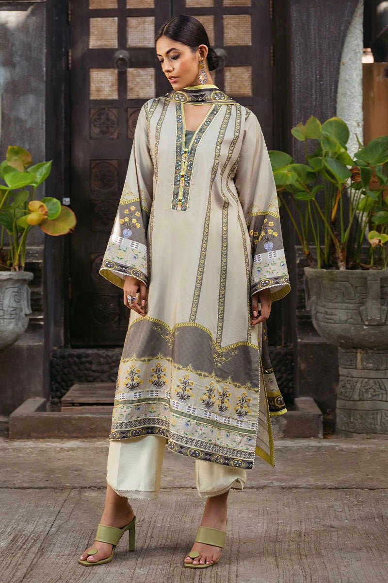 Model wearing Chestnut dress from Mushq's Nirvana Silk Edit in beige and grey tones with floral accents. Pakistani winter casual pret clothes available online in the UK.