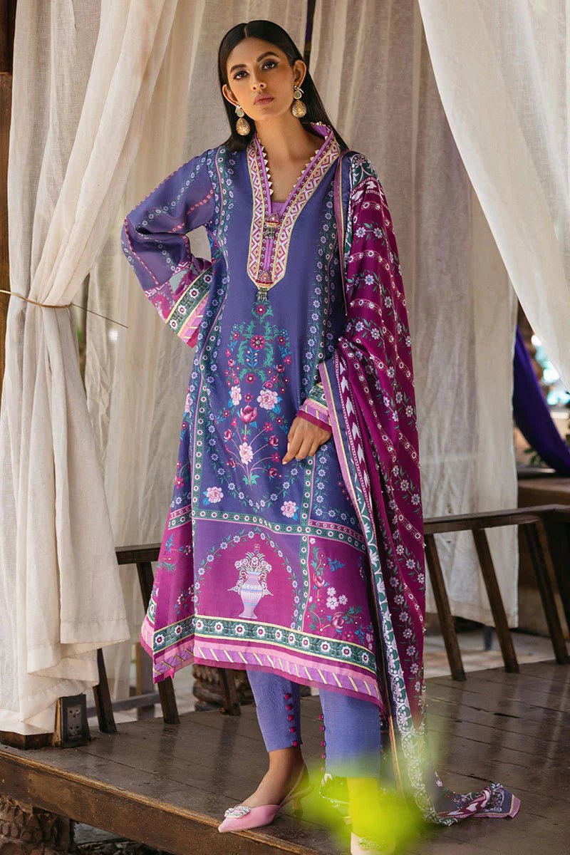 Model wearing Indigo dress from Mushq's Nirvana Silk Edit in vibrant blue and purple tones with floral and geometric patterns. Pakistani winter casual pret clothes available online in the UK.