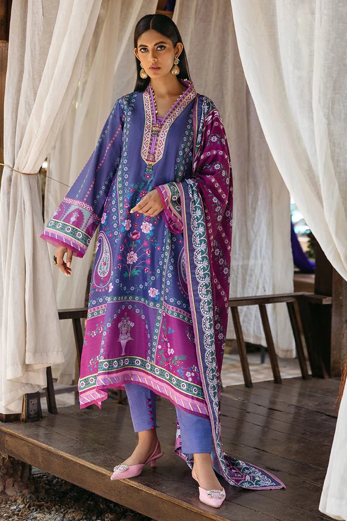 Model wearing Indigo dress from Mushq's Nirvana Silk Edit in vibrant blue and purple tones with floral and geometric patterns. Pakistani winter casual pret clothes available online in the UK.