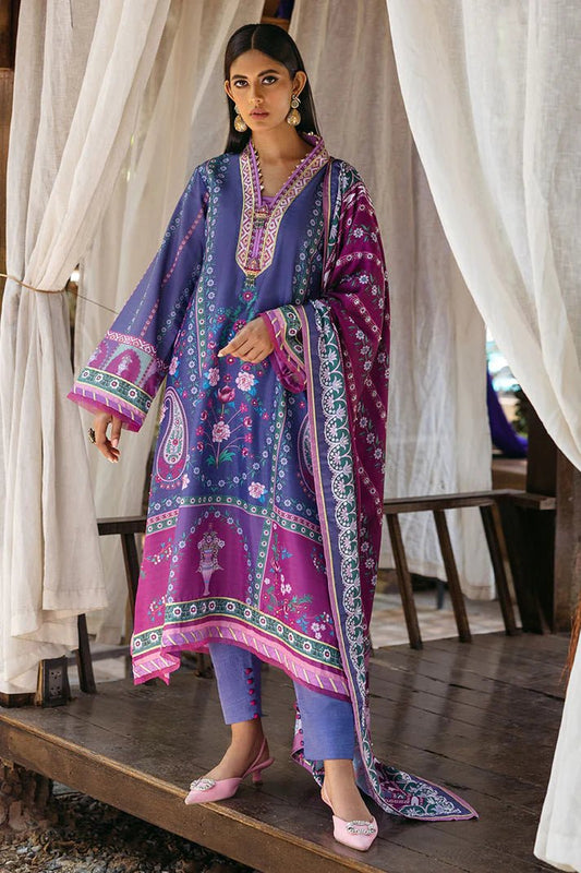 Model wearing Indigo dress from Mushq's Nirvana Silk Edit in vibrant blue and purple tones with floral and geometric patterns. Pakistani winter casual pret clothes available online in the UK.