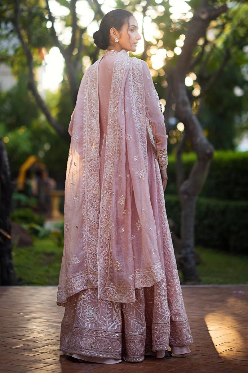 Model wearing Mushq Roohi Luxury Collection Aanya dress in blush pink, highlighting intricate embroidery. Perfect for Pakistani wedding clothes online in UK.