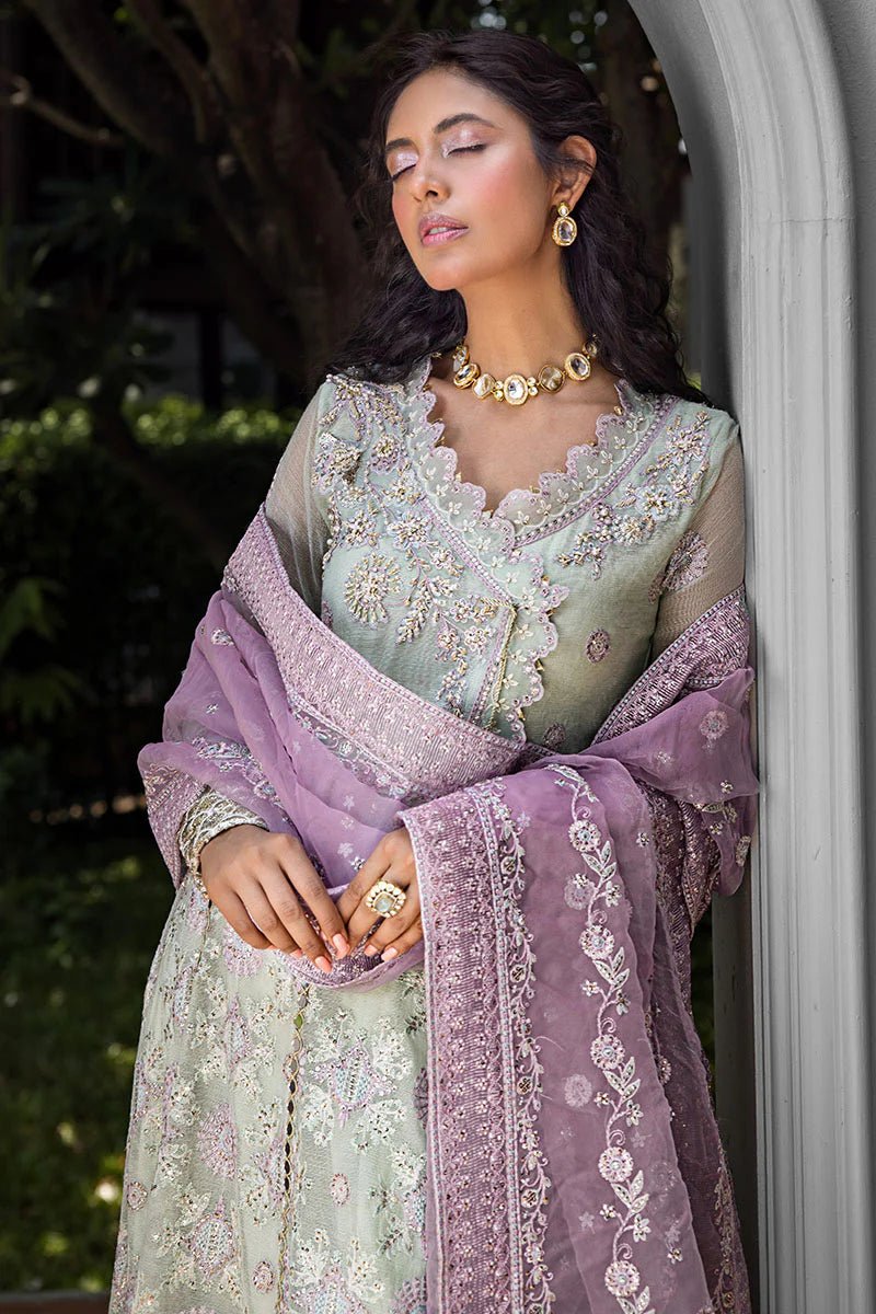 Model wearing a green dress with intricate embroidery from Mushq's Roohi Luxury Collection. Ideal for Pakistani wedding clothes online in UK.