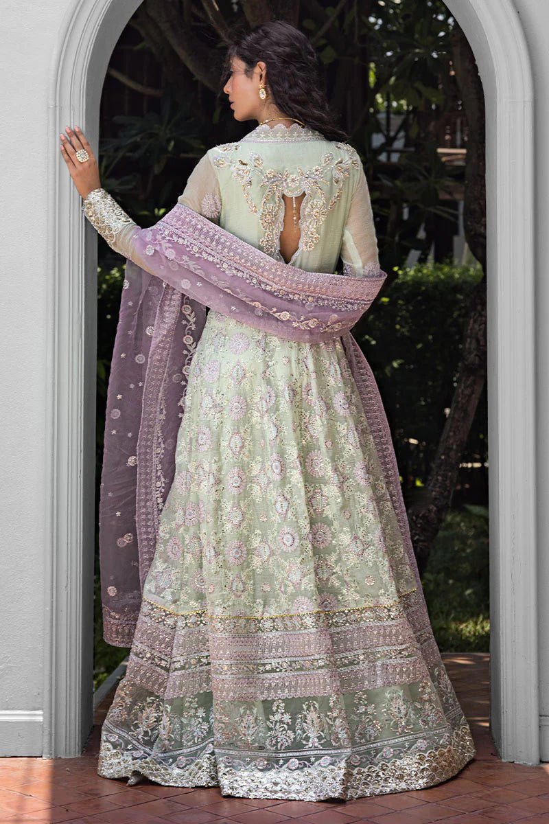 Model wearing a green dress with intricate embroidery from Mushq's Roohi Luxury Collection. Ideal for Pakistani wedding clothes online in UK.