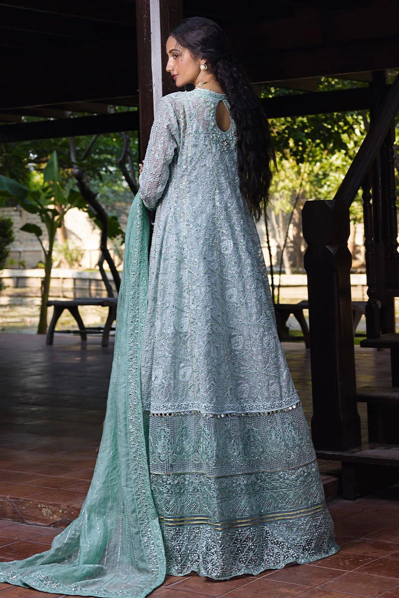 Model wearing a pastel green embroidered Diya dress from Mushq's Roohi Luxury Collection. Perfect for Pakistani clothes online in UK and wedding attire.