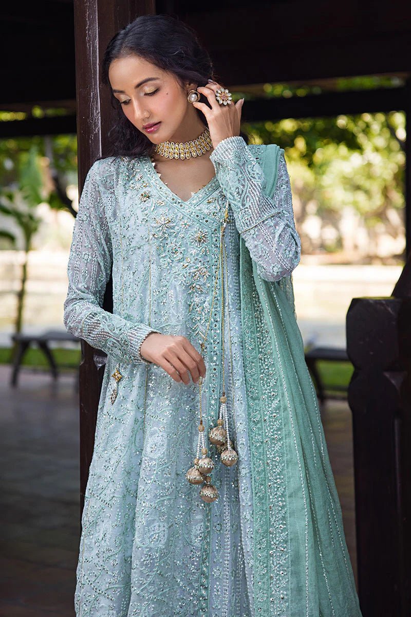 Model wearing a pastel green embroidered Diya dress from Mushq's Roohi Luxury Collection. Perfect for Pakistani clothes online in UK and wedding attire.