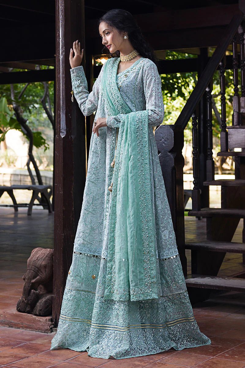 Model wearing a pastel green embroidered Diya dress from Mushq's Roohi Luxury Collection. Perfect for Pakistani clothes online in UK and wedding attire.