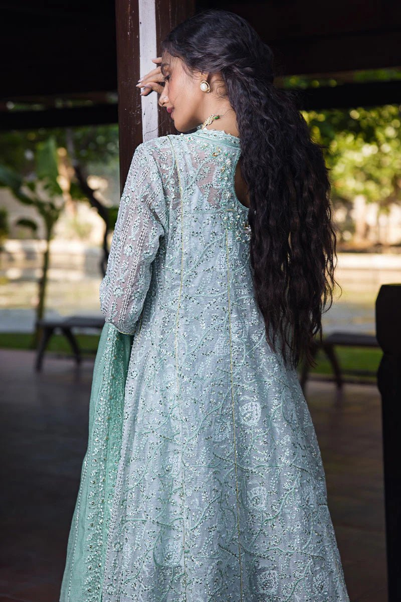 Model wearing a pastel green embroidered Diya dress from Mushq's Roohi Luxury Collection. Perfect for Pakistani clothes online in UK and wedding attire.