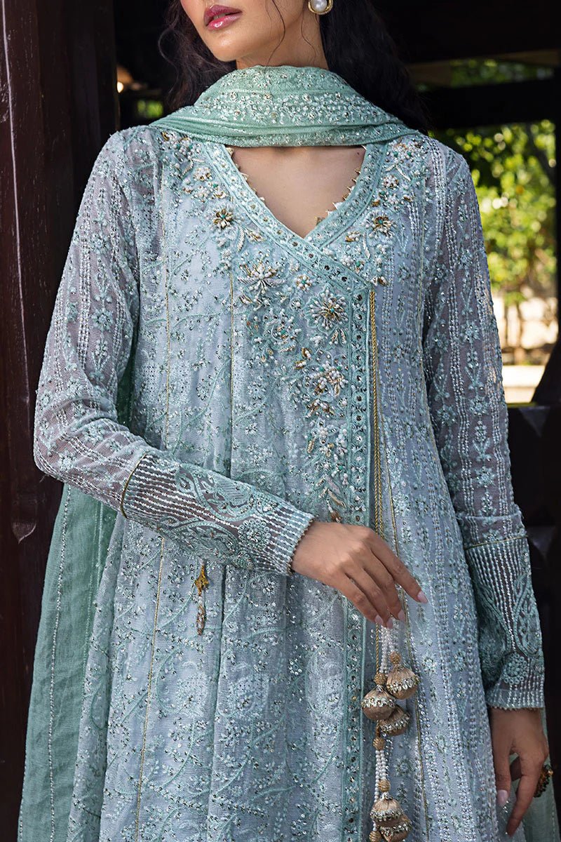 Model wearing a pastel green embroidered Diya dress from Mushq's Roohi Luxury Collection. Perfect for Pakistani clothes online in UK and wedding attire.