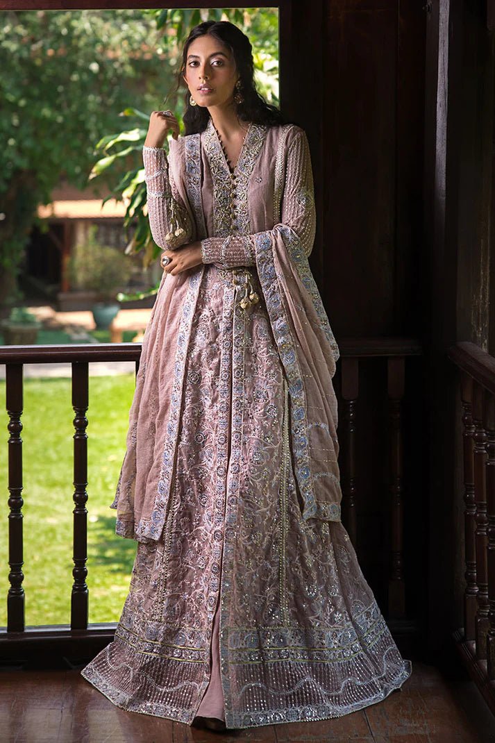 Model wearing Mushq Janvi dress in dusty pink. Shop Pakistani wedding clothes online in the UK. Discover Mushq's Roohi Luxury Collection.