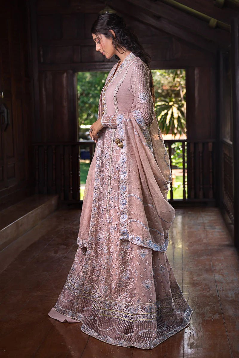 Model wearing Mushq Janvi dress in dusty pink. Shop Pakistani wedding clothes online in the UK. Discover Mushq's Roohi Luxury Collection.