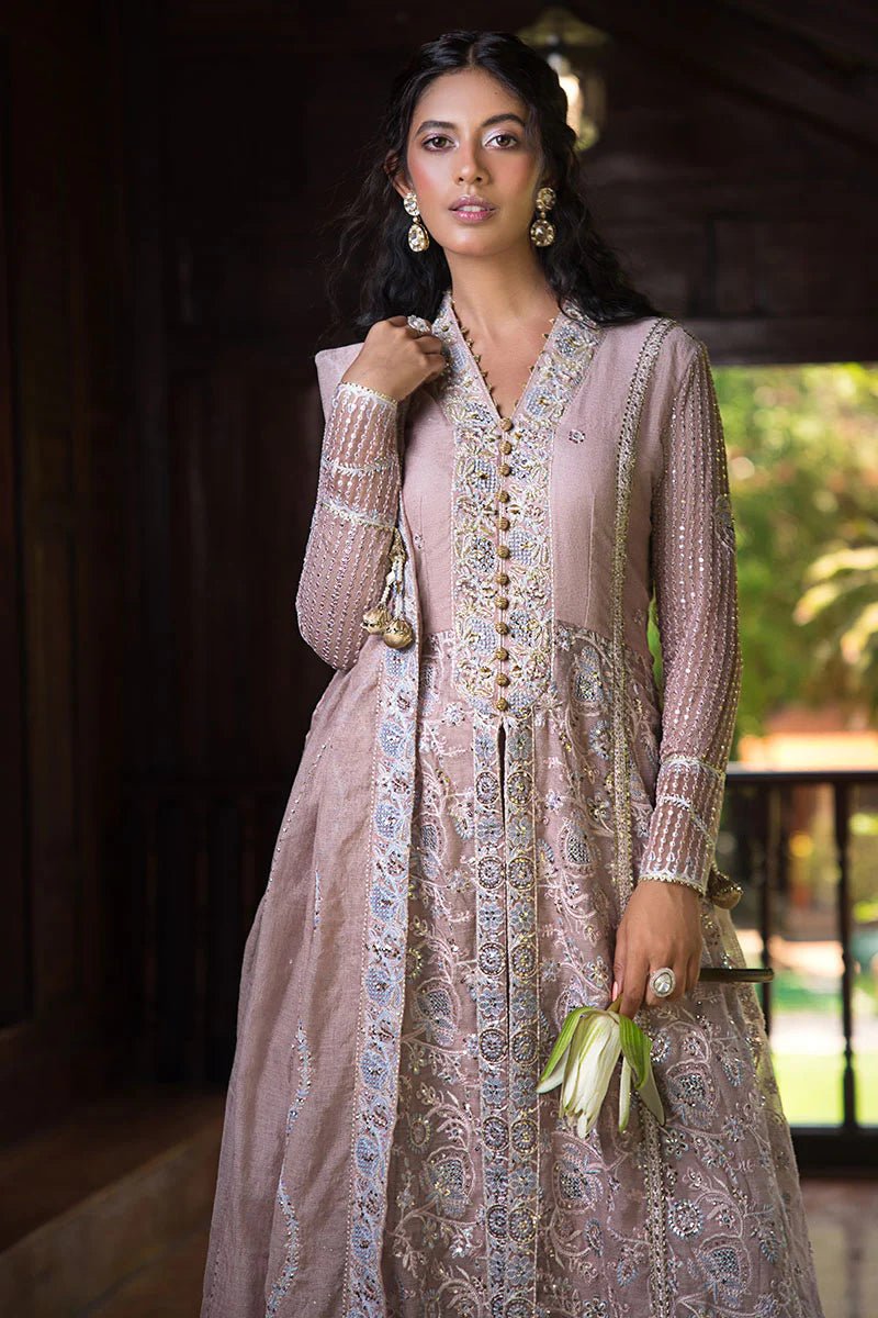 Model wearing Mushq Janvi dress in dusty pink. Shop Pakistani wedding clothes online in the UK. Discover Mushq's Roohi Luxury Collection.