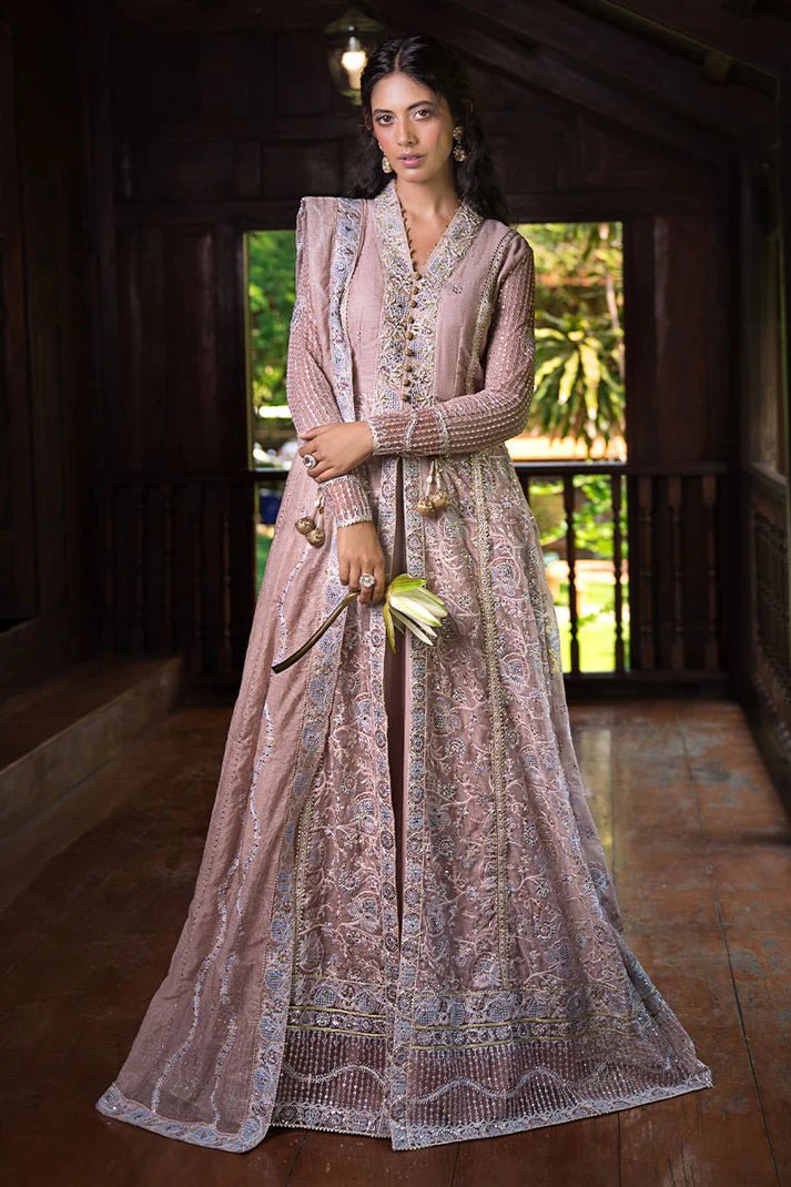 Model wearing Mushq Janvi dress in dusty pink. Shop Pakistani wedding clothes online in the UK. Discover Mushq's Roohi Luxury Collection.