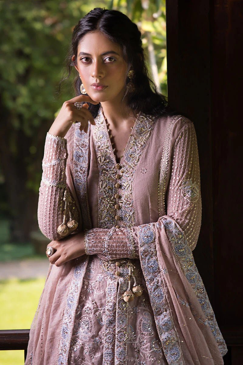 Model wearing Mushq Janvi dress in dusty pink. Shop Pakistani wedding clothes online in the UK. Discover Mushq's Roohi Luxury Collection.