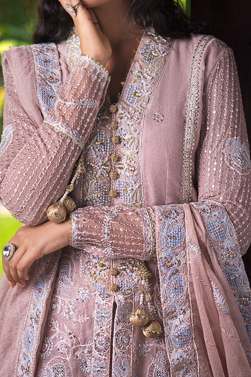 Model wearing Mushq Janvi dress in dusty pink. Shop Pakistani wedding clothes online in the UK. Discover Mushq's Roohi Luxury Collection.