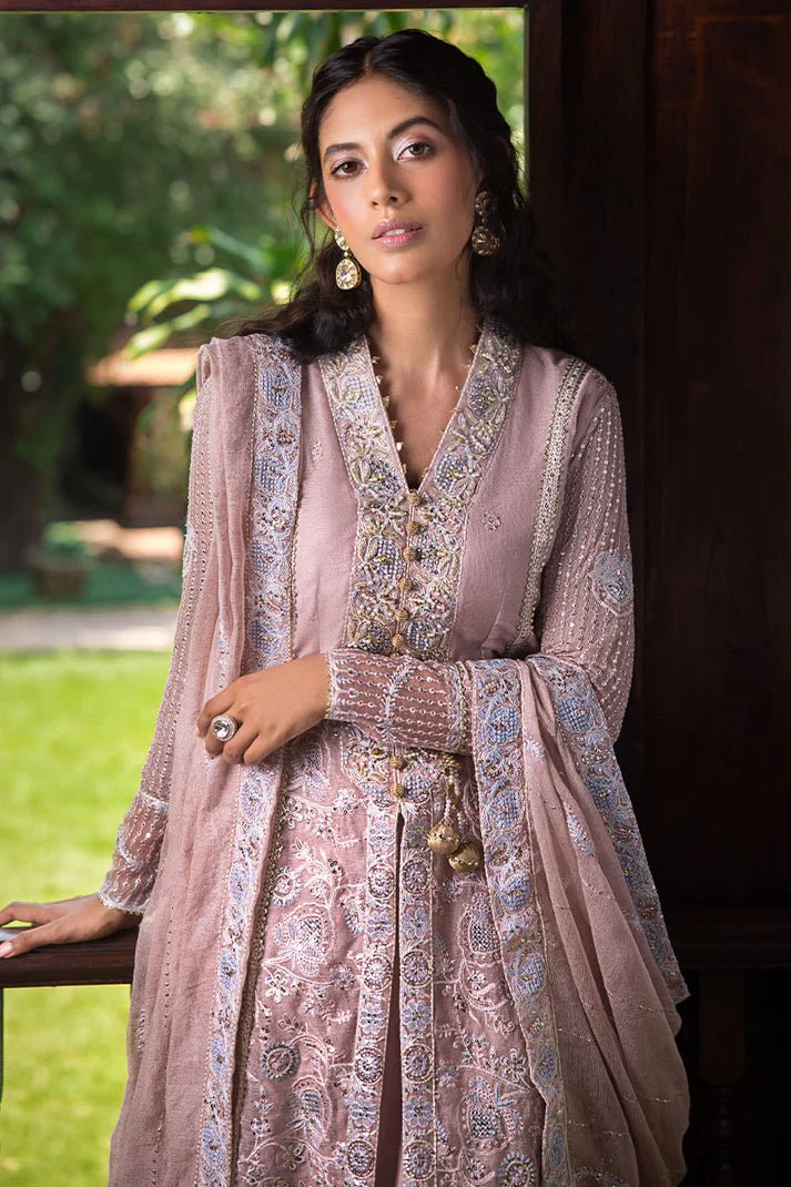 Model wearing Mushq Janvi dress in dusty pink. Shop Pakistani wedding clothes online in the UK. Discover Mushq's Roohi Luxury Collection.