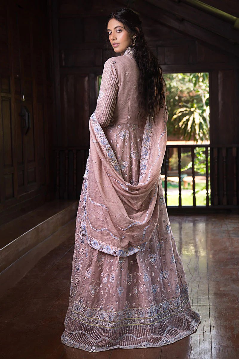 Model wearing Mushq Janvi dress in dusty pink. Shop Pakistani wedding clothes online in the UK. Discover Mushq's Roohi Luxury Collection.